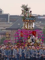 夕日をバックに山車を曳いている