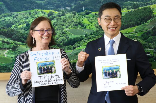 色紙交換で親睦を深めるヴィニス市長（左）と久保田市長