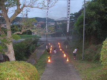 道端で燃やされる松明の様子
