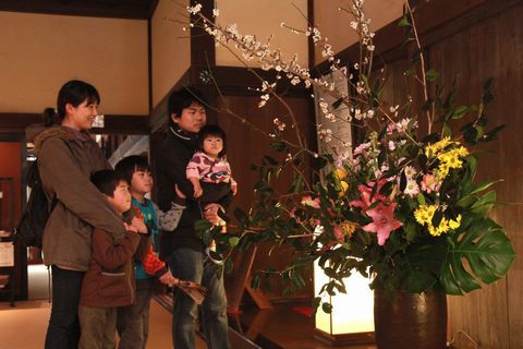 掛川城御殿に飾られた生け花を楽しむ親子連れ