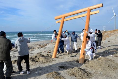 大東温泉シートピア南の国安海岸に鳥居を設置する関係者たち