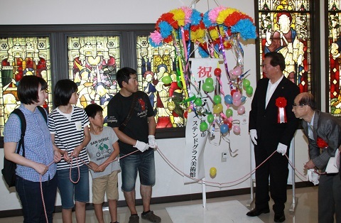 掛川市ステンドグラス美術館にて、入館者数100,000人を記念してくす玉を割る井上さん家族
