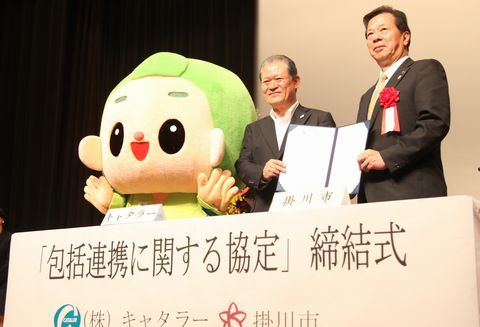 包括連携協定を締結した砂川社長（左）、松井市長。掛川市のゆるキャラ、茶のみやきんじろうと並んだ記念写真